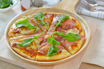 Ham cheese pizza on wooden plate cutting board style