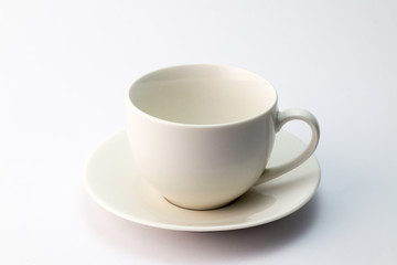 Empty white ceramic teacup and saucer isolated on white background