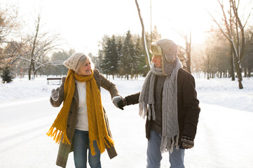 Senior couple in sunny winter nature on a walk.