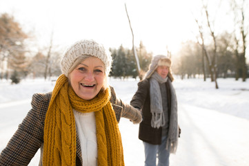 Senior couple in sunny winter nature on a walk.