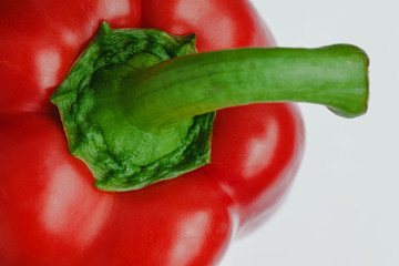 Red bell pepper closeup isolated on white background.