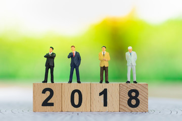 Businessmen stand on the wood block 2 0 1 8 used as a business guide next year.