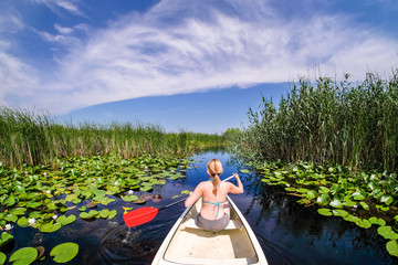 Woman sailing in Danube Delta with a boat