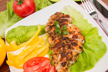 Chicken fillets with vegetable on the side (avocado, tomato, bell pepper)