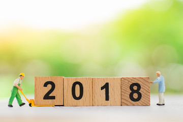 Miniature people: Work hard for bonus in next year (2018), using as business concept