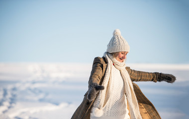 Beautiful senior woman on a walk, winter day.