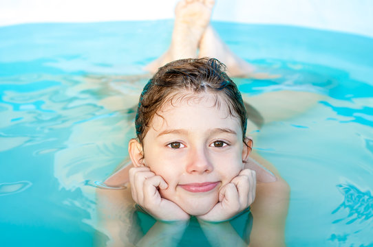 The boy is bathing in a frame pool