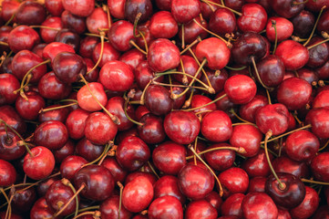 Background of ripe juicy cherries, which are sold at the farmers market.