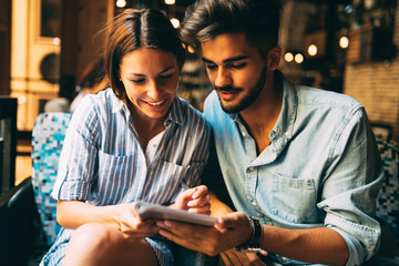 Young attractive couple on date in coffee shop