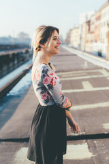 sideway view young woman outdoor back light having fun looking camera - happiness, serene, girl...