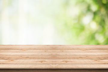 Wood table top on nature green blurred background,for montage your products
