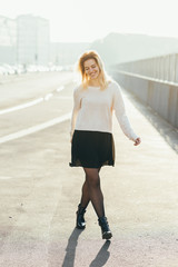 young woman walking outdoor back light having fun looking camera - happiness, serene, girl power...