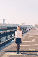 young woman posing outdoor back light having fun looking camera - happiness, serene, girl power concept