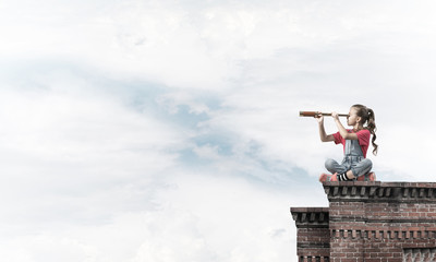 Concept of careless happy childhood with girl exploring this wor