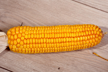 Fresh sweet corn on wooden table