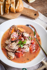 Cooked mussels in tomato sauce.