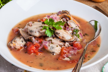 Cooked mussels in tomato sauce.