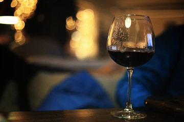glass of alcohol with ice on blured background with circle bokeh