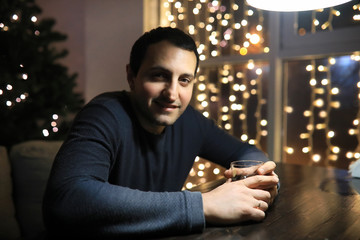 man with glass of whisky in the pub on night