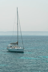 Fototapeta premium A sailing yacht under way on tropical sea