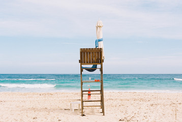 Empty lifeguard chair on white sand Caribbean beach