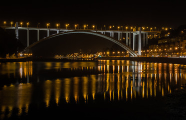 Fototapeta na wymiar Arrabida Bridge Porto Portugal Water Reflection Douro River Night Landscape