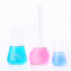 Chemical laboratory beakers with colorful liquids and reagents. Research science and medical laboratory.