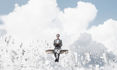 Fototapeta premium Young businessman or student studying the science and symbols fl