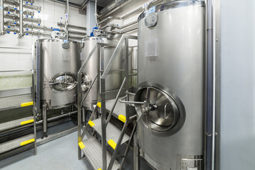 Large steel tanks for mixing liquids, modern production of alcoholic beverages.