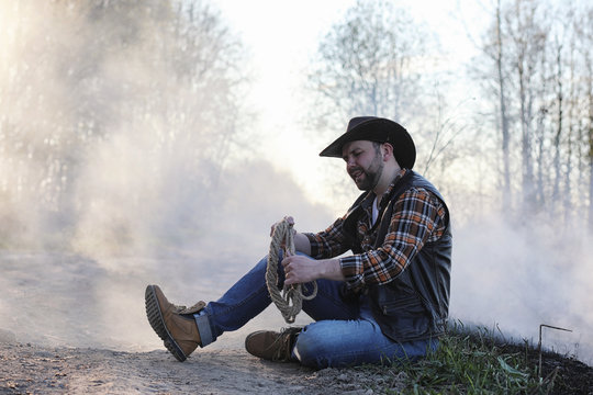 A cowboy in a thick smoke on the road