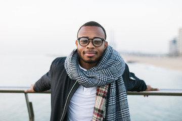 Portrait of an african american man standing outside on winter.