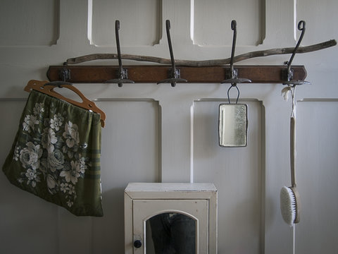 Interior of a Hipster Vintage decorated bathroom in England with wood panelled wall and coat hooks