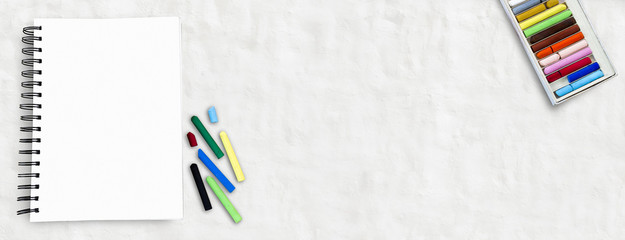 Oil pastels crayons colorful picking and art drawing paper with copy space for text on white background.