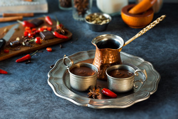 Spicy Spanish Hot Chocolate in Metal Cups with Ingredients on Kitchen Counter