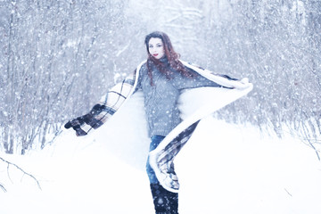 Fototapeta na wymiar Beautiful girl in a beautiful winter snow