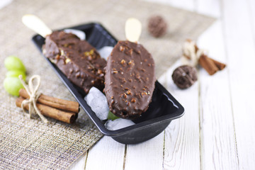 Dessert chocolate ice cream with nuts on wooden stick