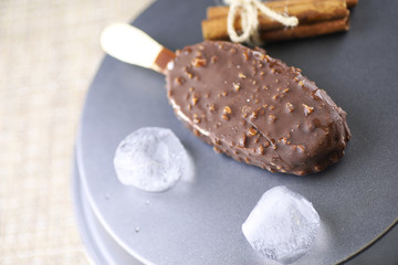 Dessert chocolate ice cream with nuts on wooden stick