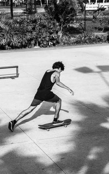 Young skater driving his skateboard on sunny day.