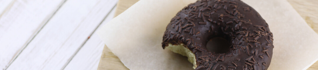 Horizontal bakground of chocolate donuts on a table