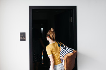Woman walking into hotel room