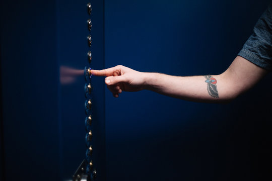 Man Pushing Elevator Button