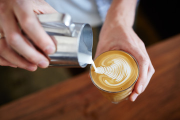 Close-up of bartender making latte