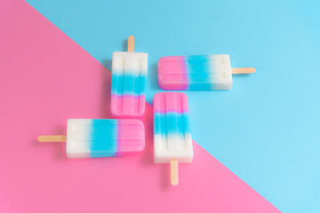 Fruit Ice cream stick , popsicle , ice pop or freezer pop with copyspace on blue and pink pastel background or texture