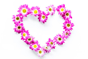 Floral frame. Heart of pink flowers on white background top view copyspace
