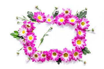 Floral frame of pink flowers on white background top view copyspace
