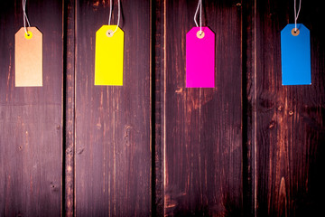 Multicolor sale tags or label on dark wooden background