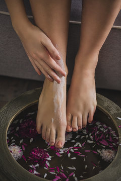 Legs of a Woman Having a Relaxing Flower Bath