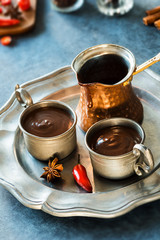 Spicy Spanish Hot Chocolate in Two Metal Cups with Pot on Tray