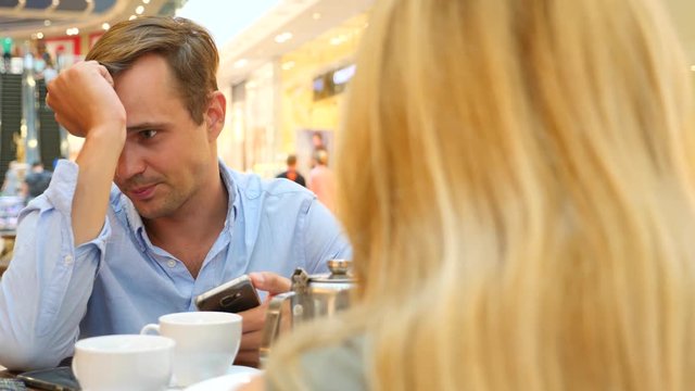 couple in cafe. beautiful Man and beautiful woman quarrel. 4k, slow-motion, close-up. copy space