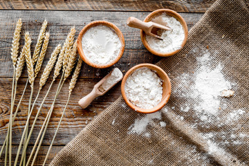wheat and rye ear for flour production on wooden desk background top view